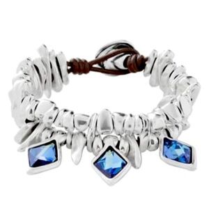 NWT UNO DE 50 BRAND NEW NEVER WORN SILVER & BLUE SWAROVSKI CRYSTAL BUTTON
UP.